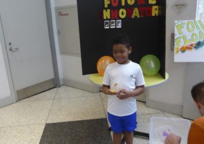 Boy with gumdrop pyramid takes Polaroid photo